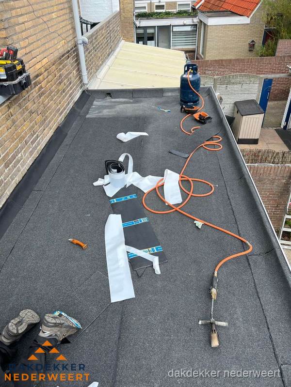 Dakdekkers bezig met bitumen dakbedekking in Nederweert